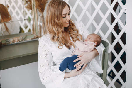 Mother with little daughter in a roomの写真素材