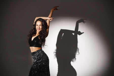 Portrait of caucasian woman salsa dancer under a projectors lightの写真素材