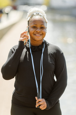 Afro-american plus size woman doing workout exercises session outdoorの写真素材