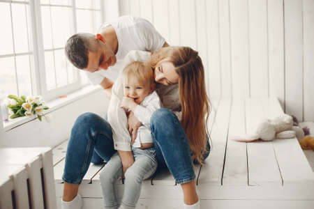 Cute and big family sitting at homeの写真素材