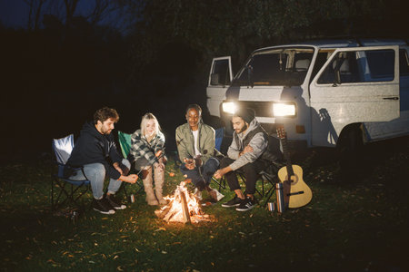 Multi ethnic friends having picnic by fireplace