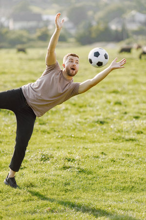Father and son playing with a ball on summer outdoors