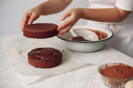 Chef spreads the cake with chocolate glaze.の写真素材
