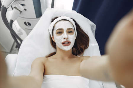 Woman standing in a cosmetology studioの写真素材