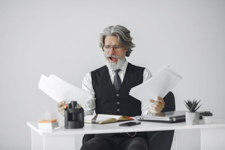 Handsome pensive mature businessman in the office
