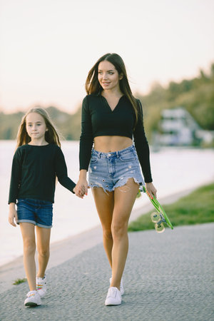 Mother and daughter having fun while skating at park