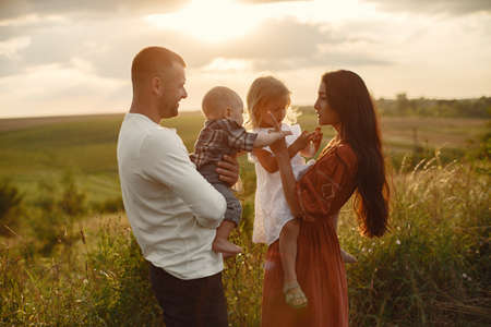 Cute family playing in a summer fieldの写真素材