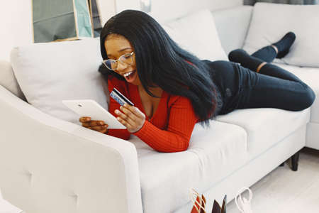 African woman online shopping at homeの写真素材