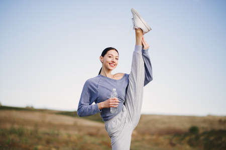 Cute girl training on a sky backgroungの写真素材