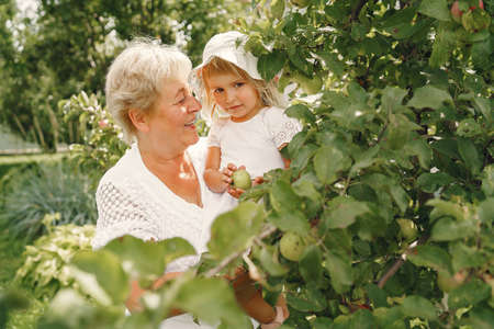 Grandmother and granddaughter enjoyed in the gardenの写真素材