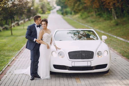 Beautiful wedding couple outside, summer Caucasiansの写真素材