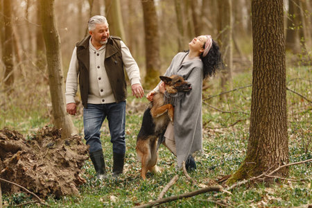 Elegant adult couple in a spring forestの写真素材
