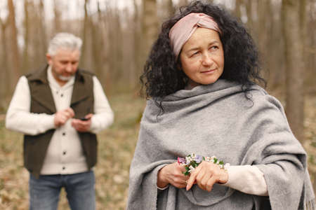 Elegant adult couple in a spring forestの写真素材