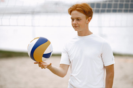 Ginger hair boy play with volleyball ballの写真素材