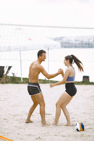 Friends having fun at voleyball playgroundの写真素材