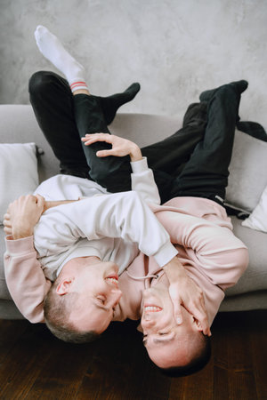 Young romantic gay couple spending day cuddling