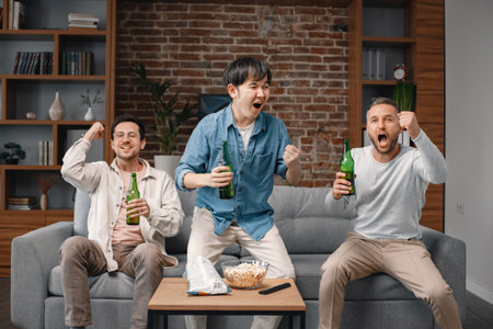 Front view of men watching a football game on tv and drinking a beer