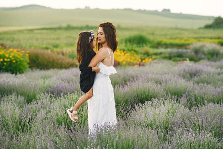 Little girl with her mother in a lavender fieldの写真素材