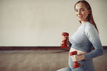 Pregnant woman training in a gym
