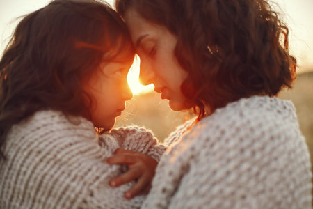 Mother with daughter playing in a summer field