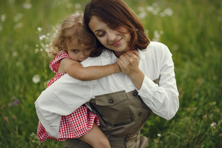 Mother with daughter playing in a summer field