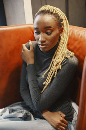 African woman sitting in a cafeの写真素材