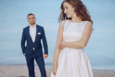 Gorgeous wedding couple doing photo shoot in the morning on the beach in Greeceの写真素材