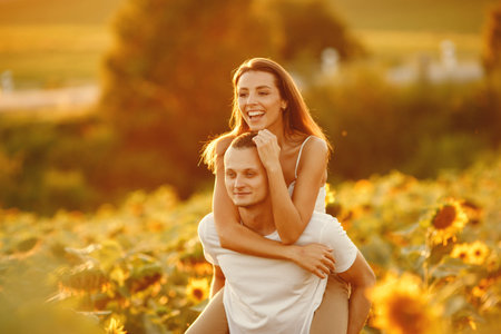 People spend time in a sunflowers field