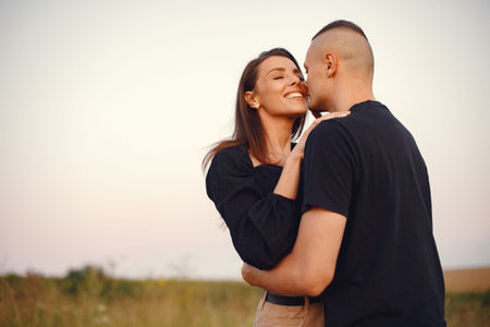 Beautiful couple spend time on a summer field