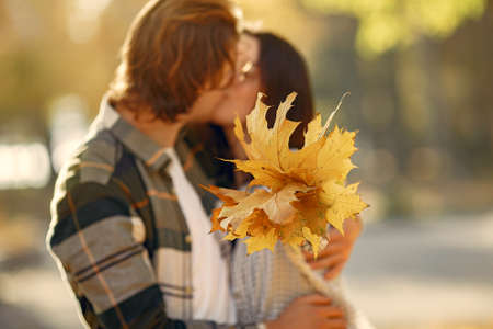 Beautiful couple spend time in a autumn parkの写真素材
