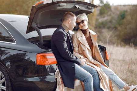 Beautiful couple spend time on a autumn fieldの写真素材