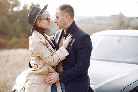 Beautiful couple spend time on a autumn fieldの写真素材