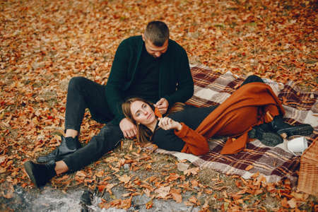 Elegant couple spend time in a autumn parkの写真素材