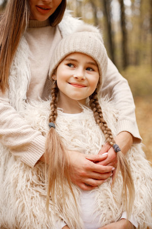 Close up portrait of a girl who playing and having fun in autumn forestの写真素材