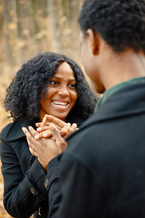 Loving black couple walking in park and enjoying autumn dayの写真素材