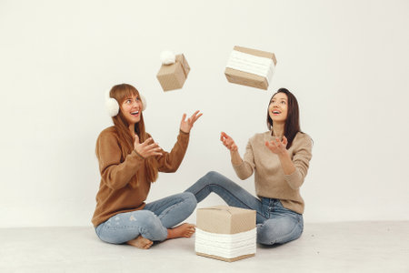 Beautiful girls have fun in a studio with presentsの写真素材