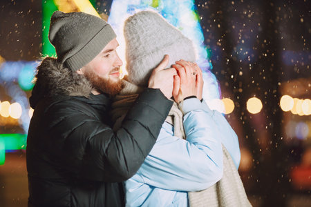 Young couple outdoor in night street at christmas timeの写真素材