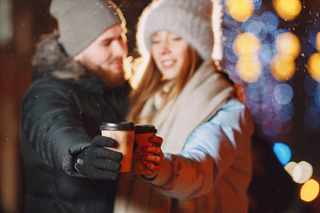 Young couple outdoor in night street at christmas timeの写真素材