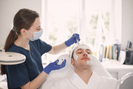 Man in cosmetologist cabinet has a skincare procedureの写真素材