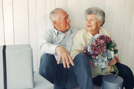 Elegant old couple sitting at home on a foorの写真素材
