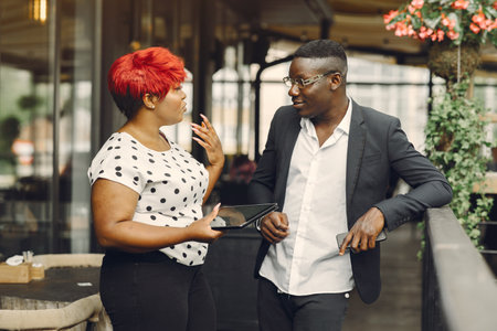 African american couple standing in a cafe with a tabletの写真素材