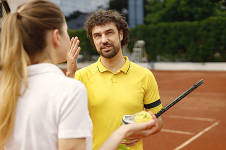 Two tennis players talking on a tennis court before the match