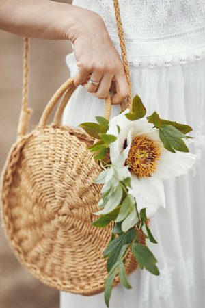 Woman in elegant dress standing in a summer fieldの写真素材