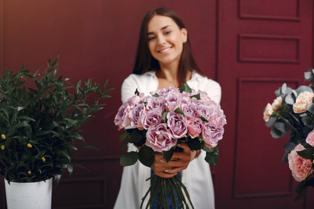 Frorist makes a beautiful bouquet in a studioの写真素材