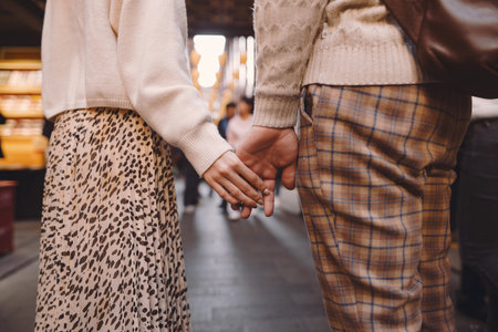 newlywed couple showing affection and holding hands in Shanghai near Yuyuan while visiting Chinaの写真素材