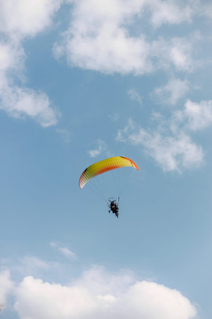 A person paragliding in a sky on a clear day