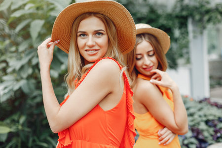Elegant and stylish girls in a greenhouseの写真素材