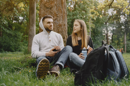Cute couple have a rest in a summer forest