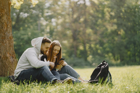 Cute couple have a rest in a summer forestの写真素材