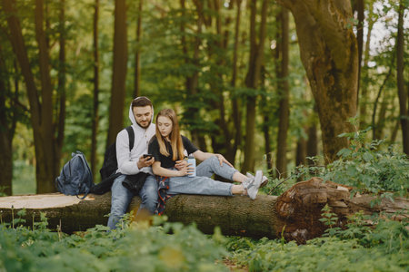 Cute couple have a rest in a summer forestの写真素材